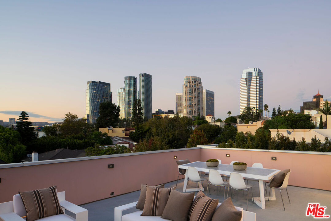 10326 Keswick Avenue Los Angeles, CA 90064 - Photo 4 of 38 a roof deck with couches and potted plants
