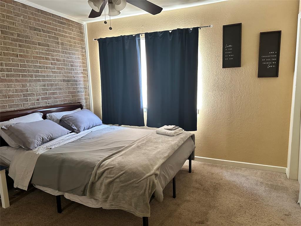 4926 Thunder Road Dallas, TX 75244 - Photo 14 of 16 a bedroom with a bed and a walk in closet