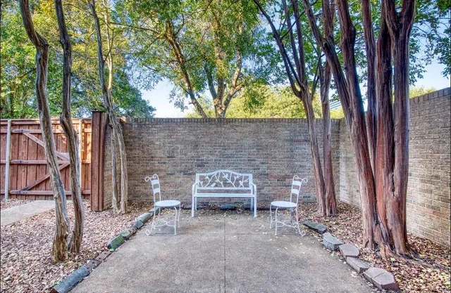 a brick building with a bench in front of it