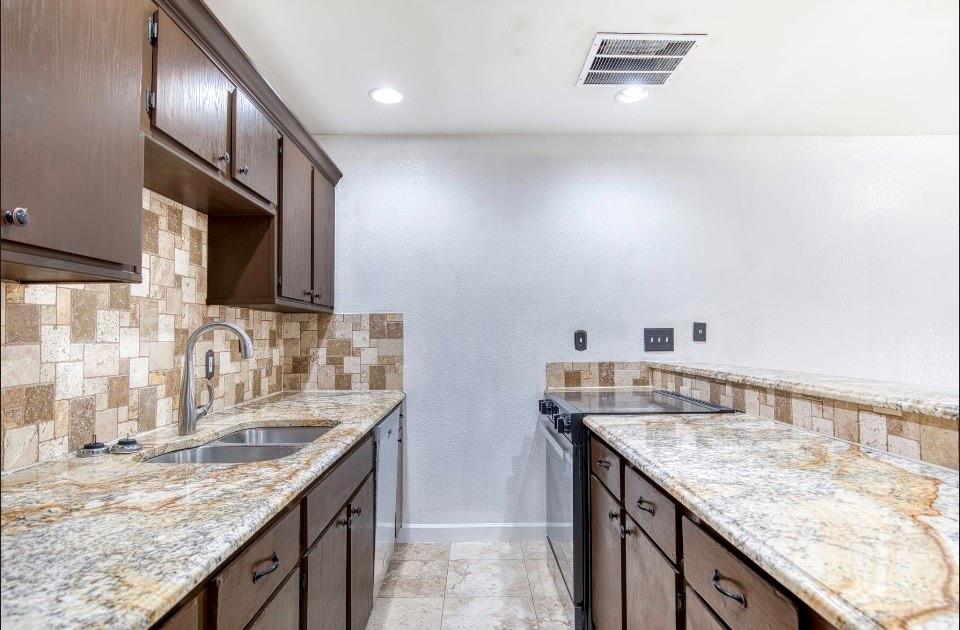 4926 Thunder Road Dallas, TX 75244 - Photo 7 of 16 a kitchen with granite countertop stainless steel appliances window a sink and a counter top space