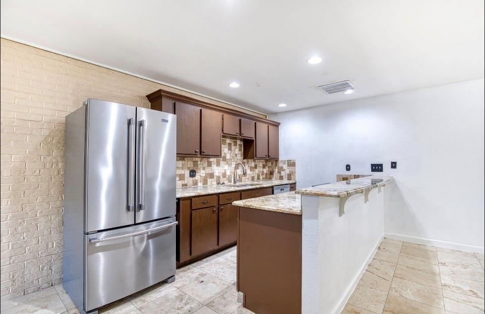 4926 Thunder Road Dallas, TX 75244 - Photo 9 of 16 a kitchen with stainless steel appliances a refrigerator sink and stove