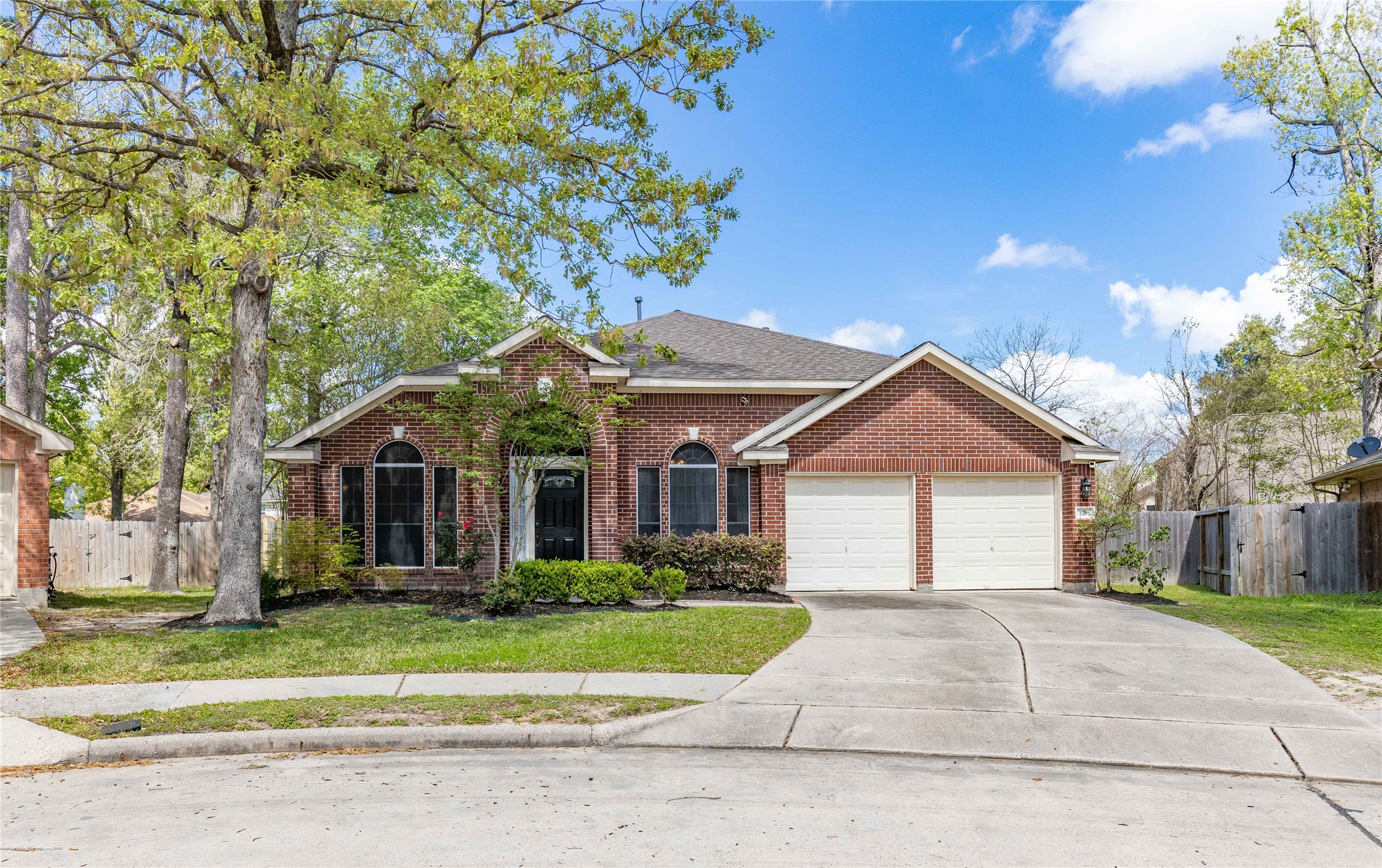 1707 Moston Drive Spring, TX 77386 - Photo 1 of 41 a front view of a house with a yard and potted plants