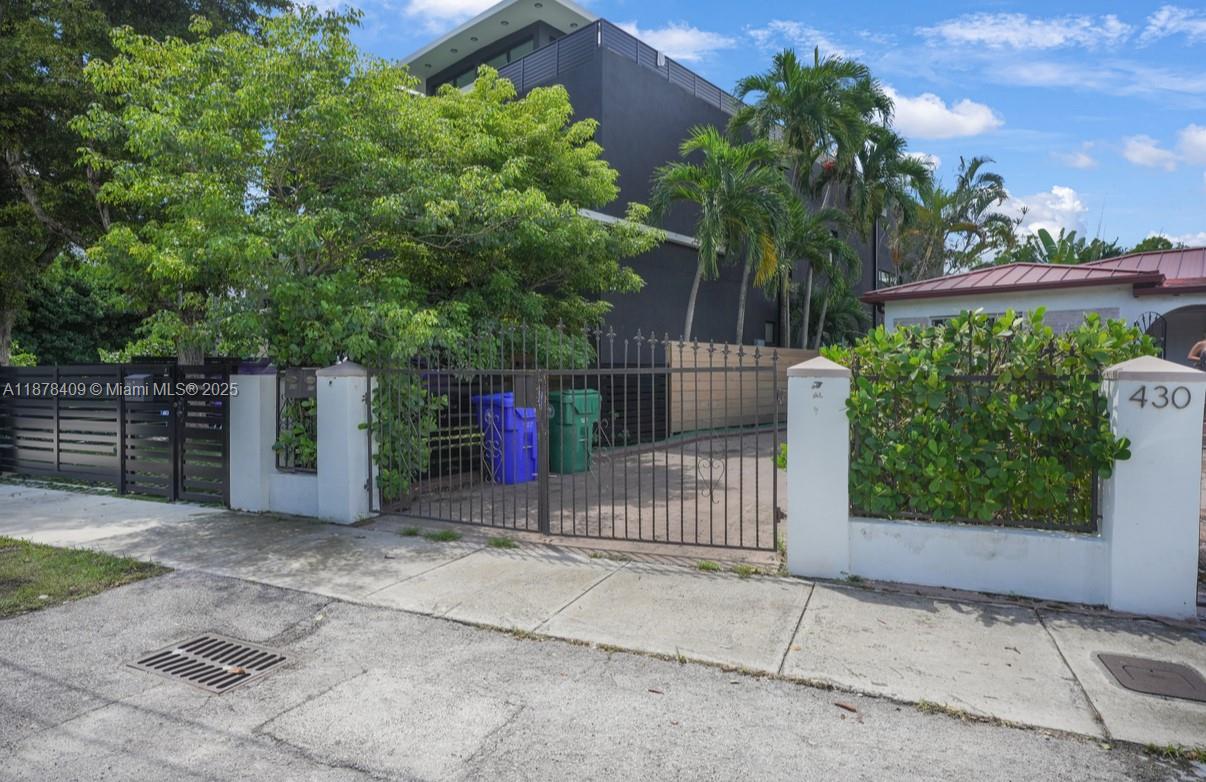 430 Southwest 15th Road Miami, FL 33129 - Photo 11 of 15 a view of a house with a fence and trees