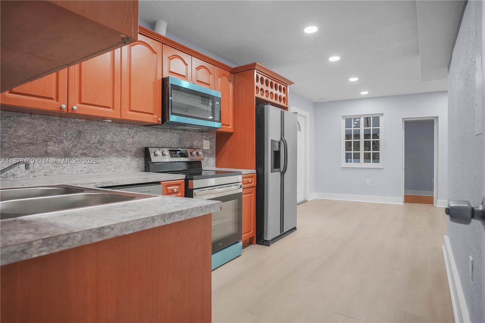 430 Southwest 15th Road Miami, FL 33129 - Photo 2 of 15 a kitchen with stainless steel appliances granite countertop a sink stove and refrigerator