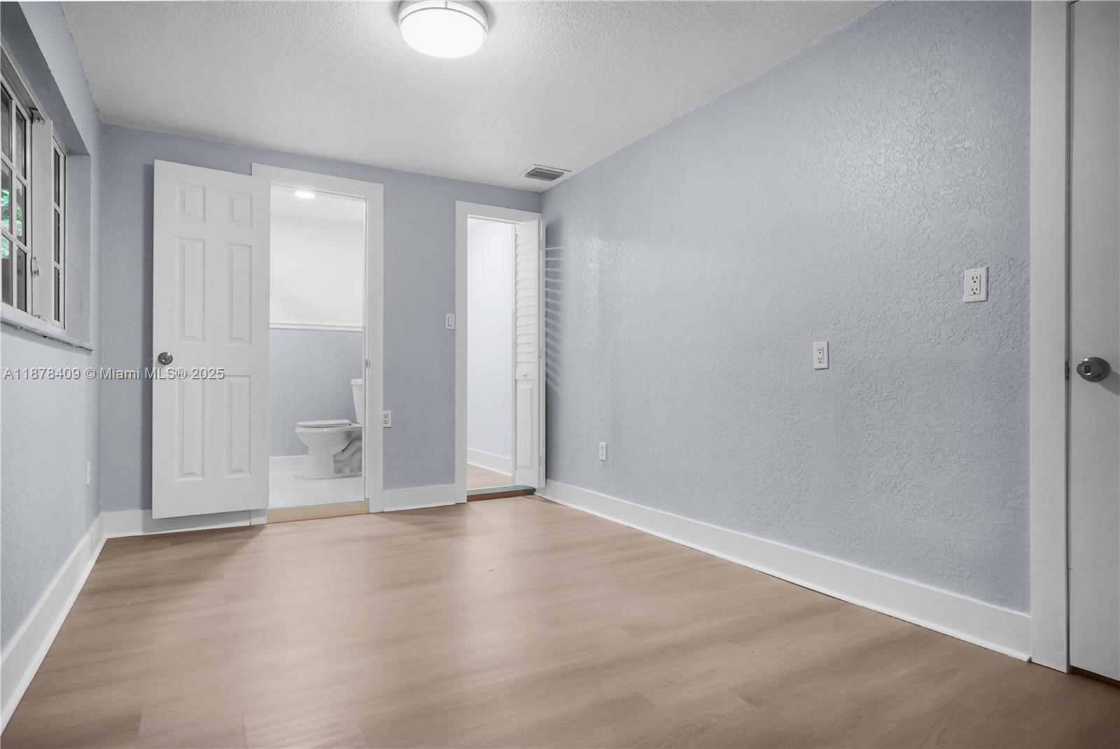 430 Southwest 15th Road Miami, FL 33129 - Photo 6 of 15 wooden floor in an empty room with a window
