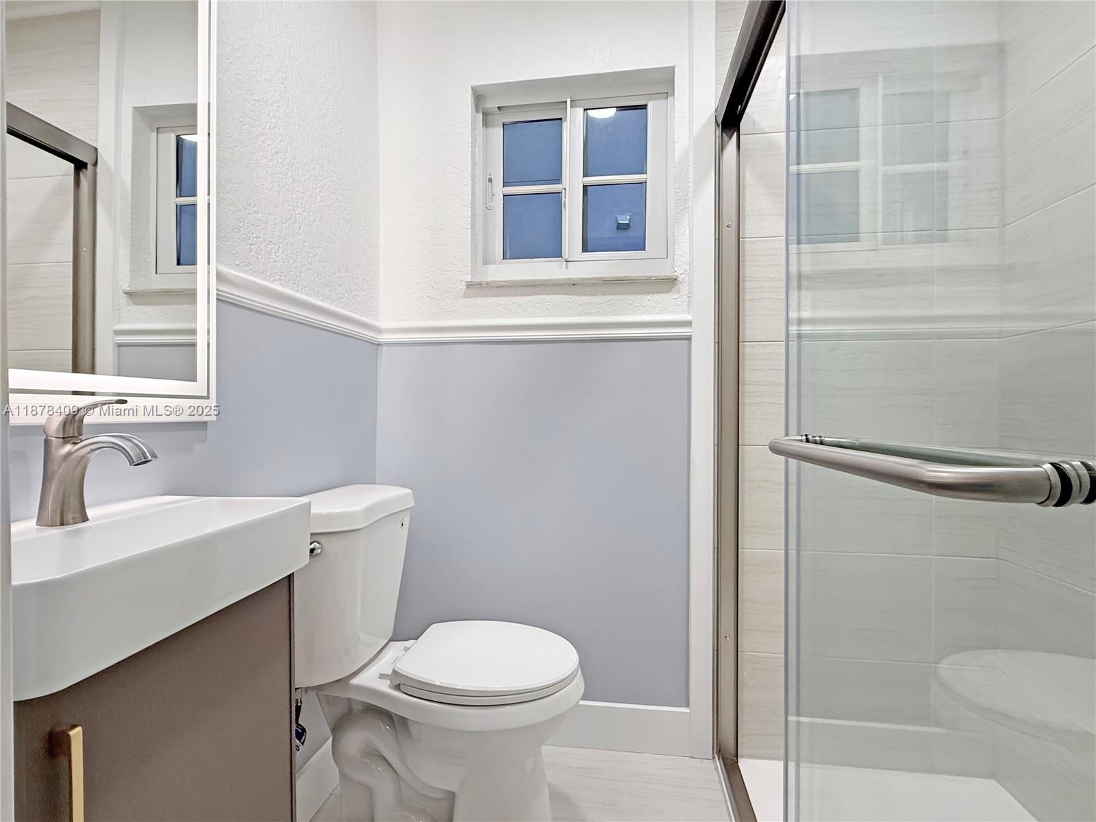 430 Southwest 15th Road Miami, FL 33129 - Photo 7 of 15 a white toilet sitting next to a bathroom sink