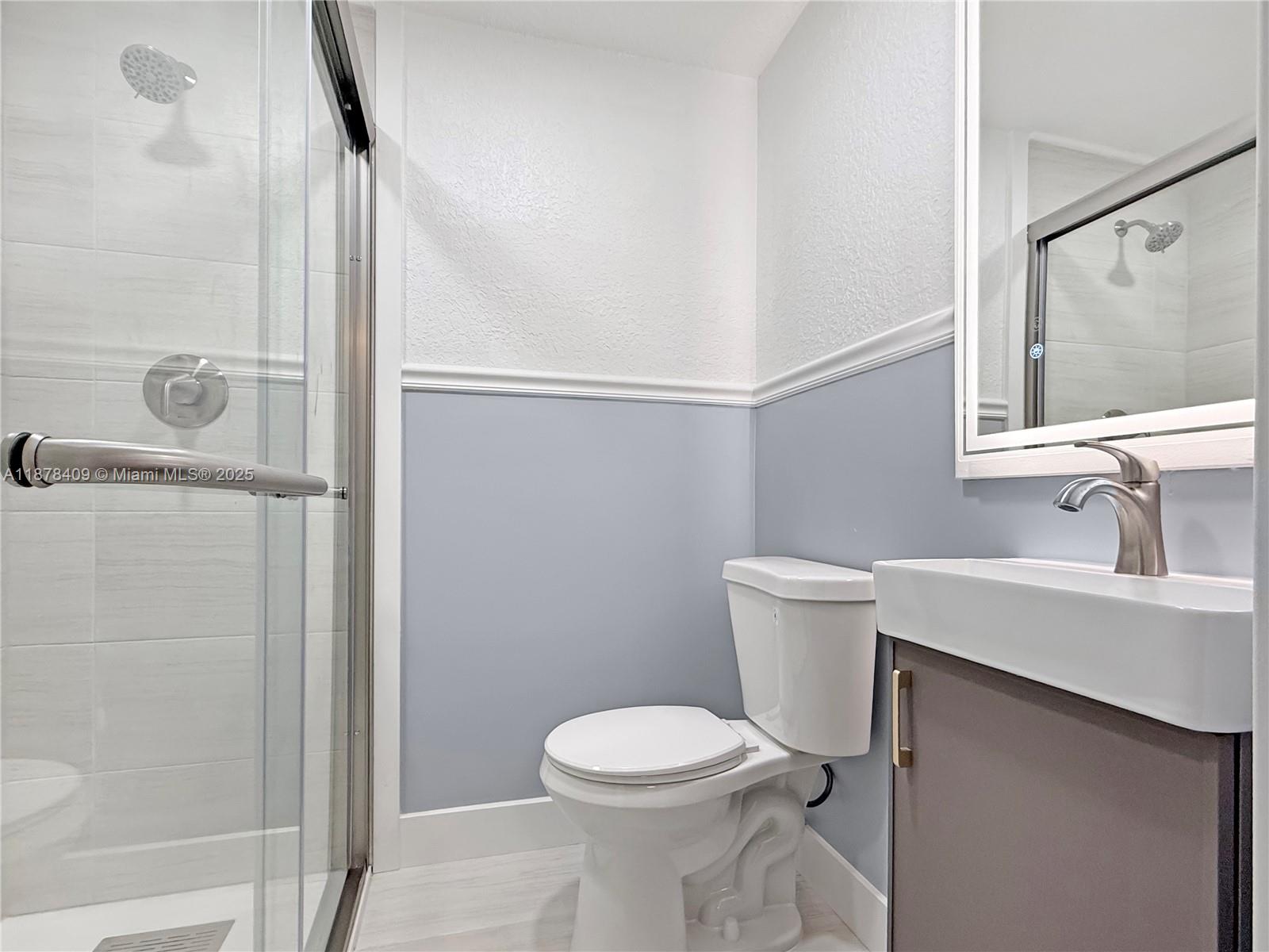 430 Southwest 15th Road Miami, FL 33129 - Photo 9 of 15 a bathroom with a sink a toilet and shower