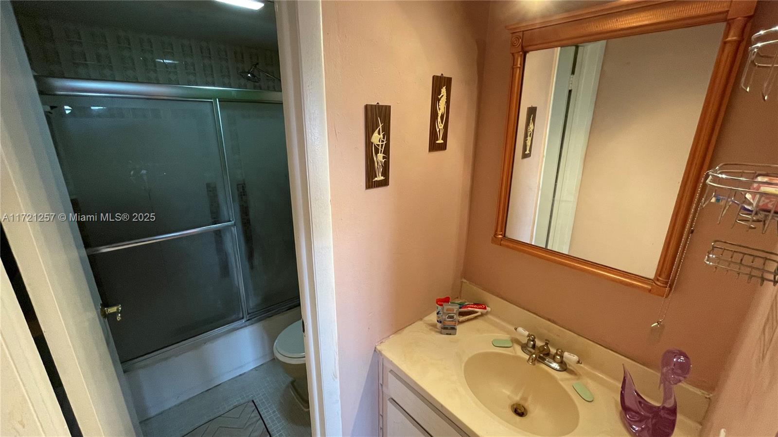 Miami Miami, FL 33138 - Photo 12 of 16 a bathroom with a sink vanity and a mirror