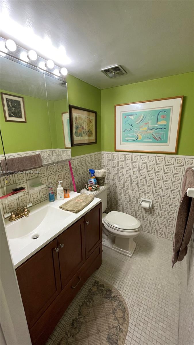 Miami Miami, FL 33138 - Photo 5 of 16 a bathroom with a toilet sink and mirror