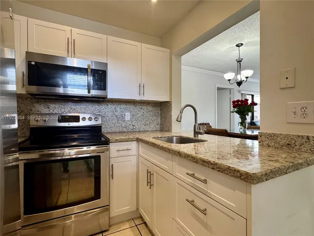 a kitchen with a sink and a stove top oven