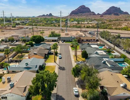 an aerial view of residential houses with outdoor space and river