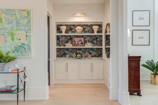 a kitchen with stainless steel appliances a stove and white cabinets