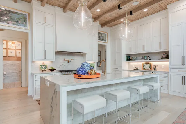 a view of staircase with lots of frames on wall and a window