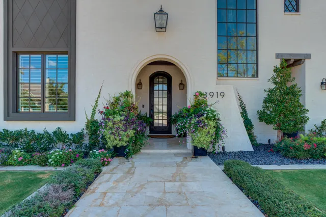 a living room with furniture a flat screen tv and a potted plant