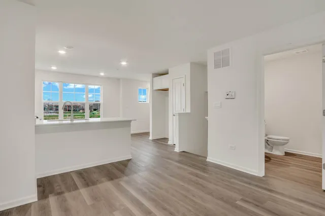 a view of a room with wooden floor and a window