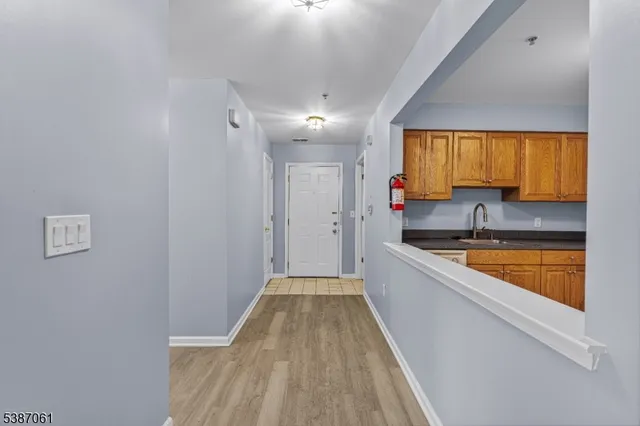a view of a kitchen with a sink and cabinets