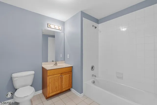 a bathroom with a granite countertop toilet a sink and bathtub