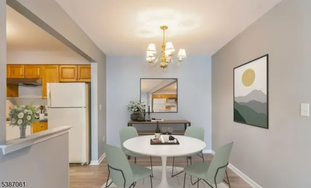 a view of a dining room with furniture and a chandelier