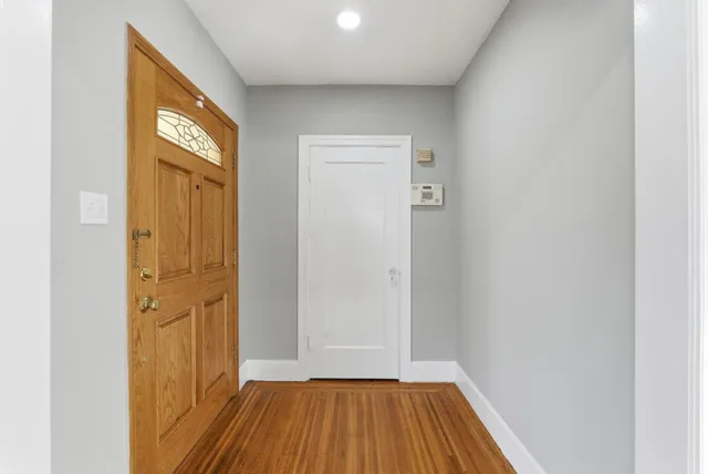 a view of a hallway with wooden floor