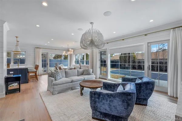 a living room with furniture and a chandelier