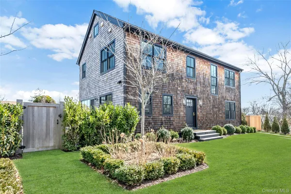 a view of a brick building next to a yard