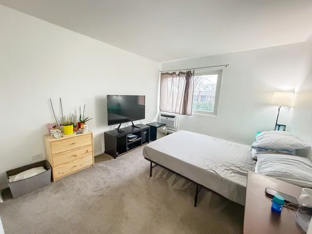 a bedroom with furniture and a flat screen tv