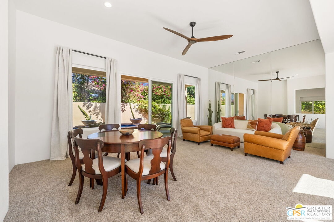 30 Vía Cielo Azul Palm Desert, CA 92260 - Photo 14 of 40 a view of a livingroom and a dining room with furniture window and outside view