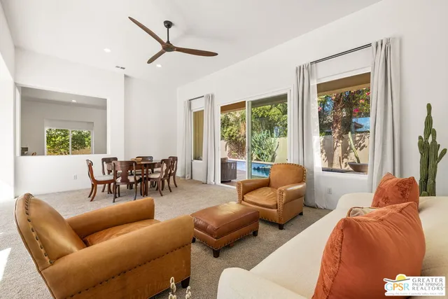 a view of a dining room with furniture large window and outside view