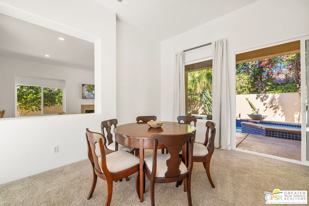 30 Vía Cielo Azul Palm Desert, CA 92260 - Photo 16 of 40 a view of a dining room with furniture large window and outside view