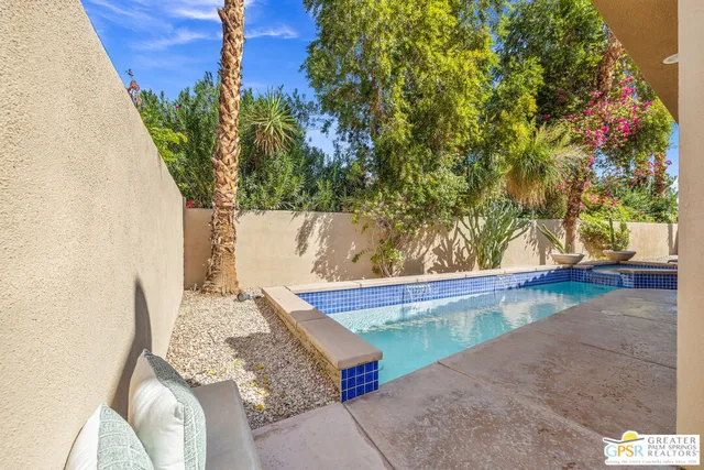 a living room with furniture a flat screen tv and a large window