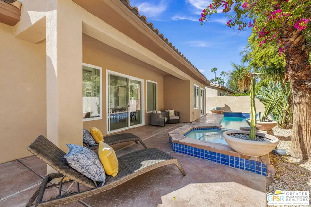 a view of a patio with couches table and chairs and potted plants