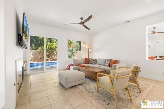 a kitchen with a table chairs refrigerator and cabinets