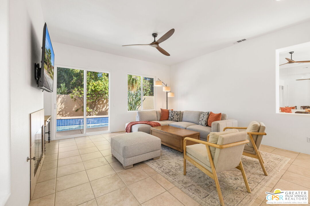 30 Vía Cielo Azul Palm Desert, CA 92260 - Photo 21 of 40 a living room with furniture a flat screen tv and a large window