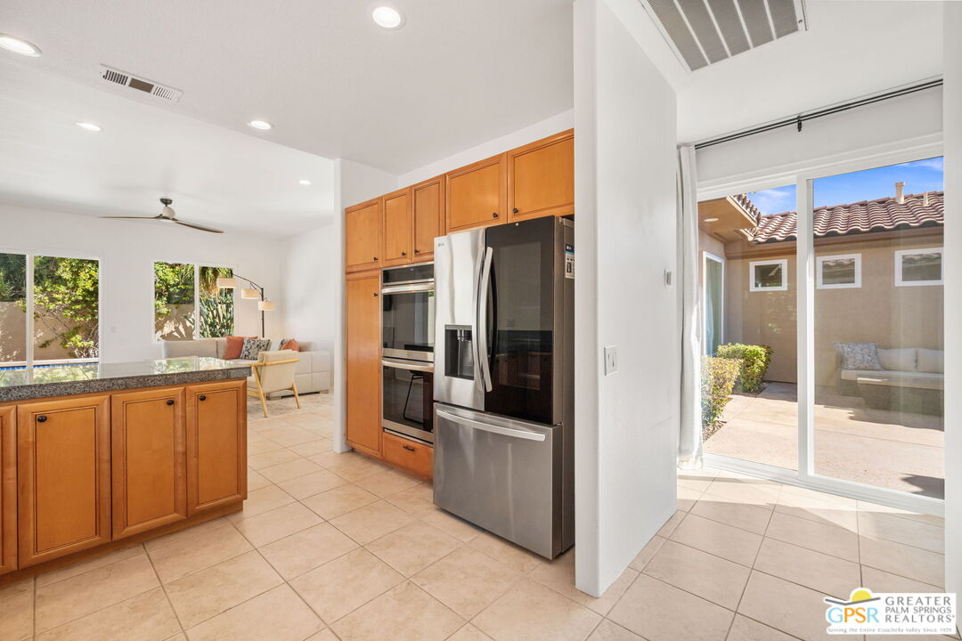 30 Vía Cielo Azul Palm Desert, CA 92260 - Photo 26 of 40 a kitchen with stainless steel appliances granite countertop a refrigerator and a sink