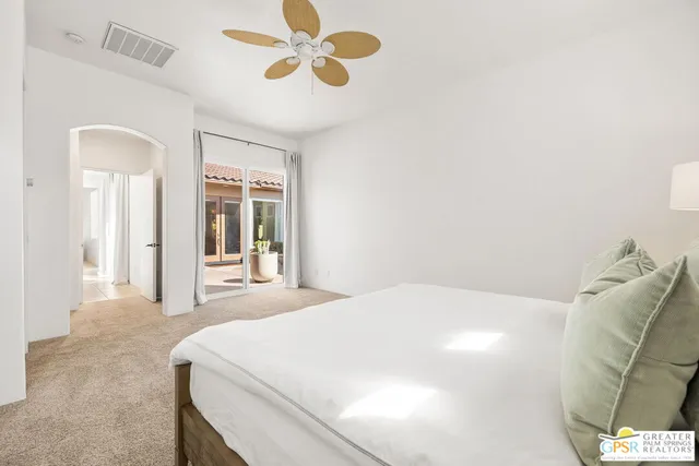a view of a patio with couple of chairs and potted plants