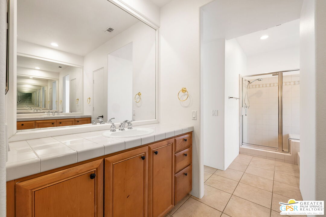 30 Vía Cielo Azul Palm Desert, CA 92260 - Photo 30 of 40 a bathroom with a sink a mirror and a shower