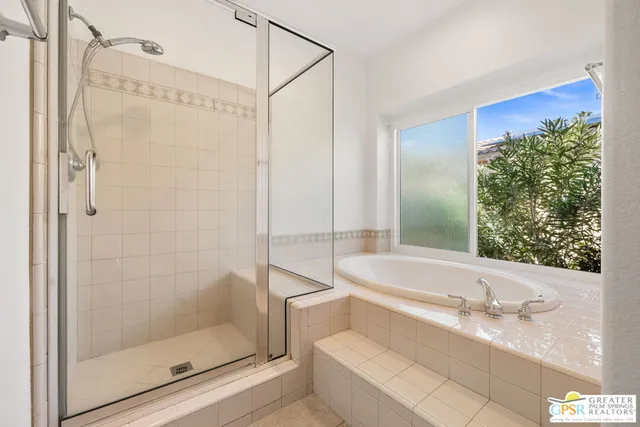 a large bathroom with a granite countertop sink two mirror and a tub