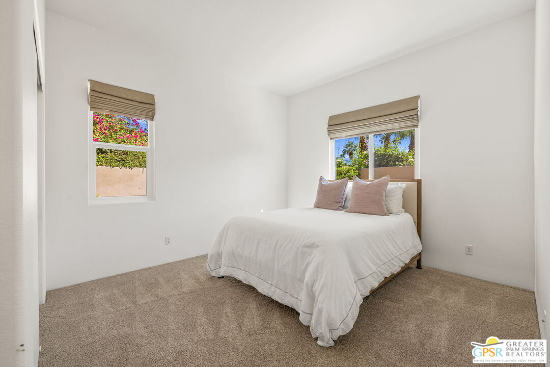 30 Vía Cielo Azul Palm Desert, CA 92260 - Photo 33 of 40 a bedroom with a bed and a painting on the wall