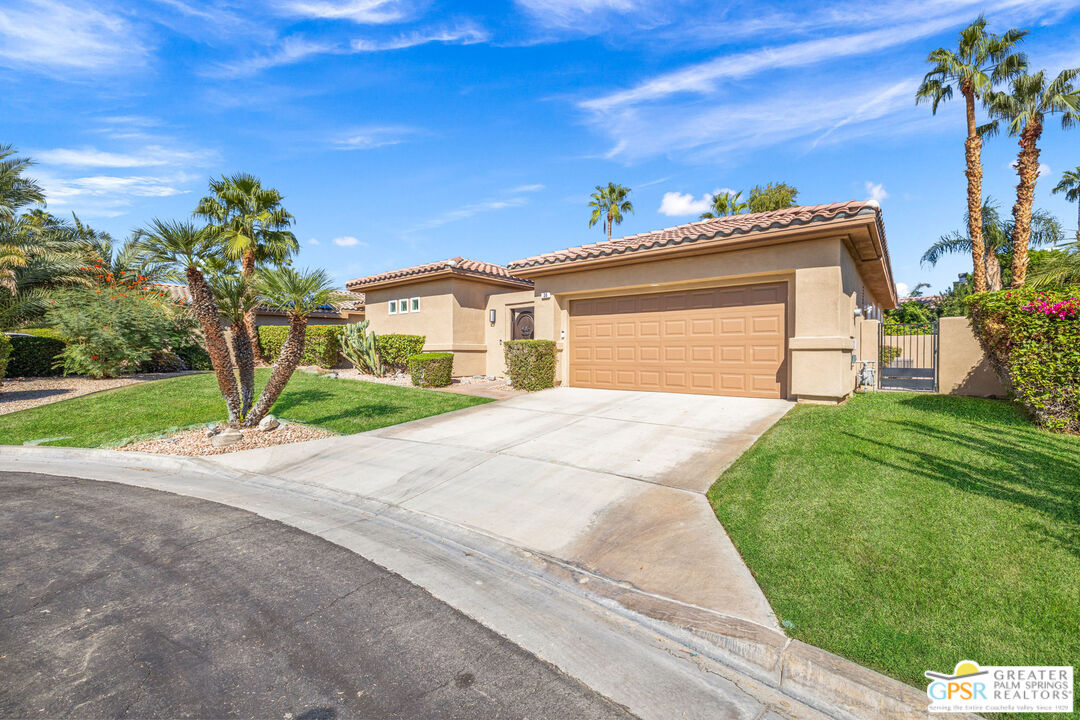 30 Vía Cielo Azul Palm Desert, CA 92260 - Photo 8 of 40 a front view of a house with a yard and garage
