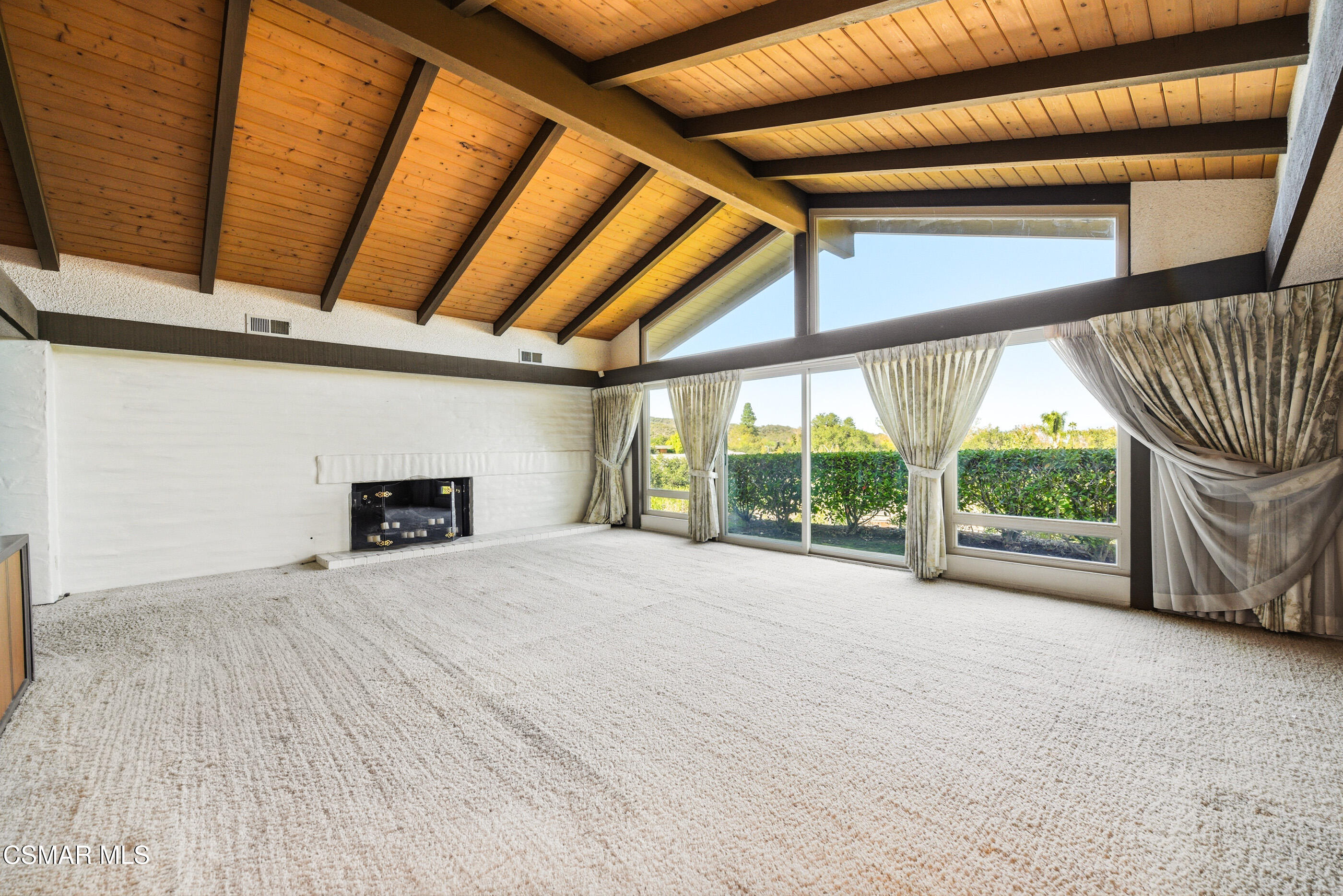 39 Inverness Road Thousand Oaks, CA 91361 - Photo 10 of 69 a view of an empty room with a fireplace and a window