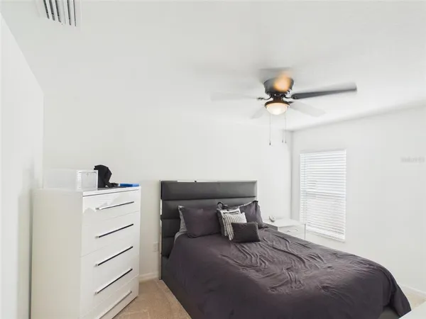a bedroom with a bed and cabinets