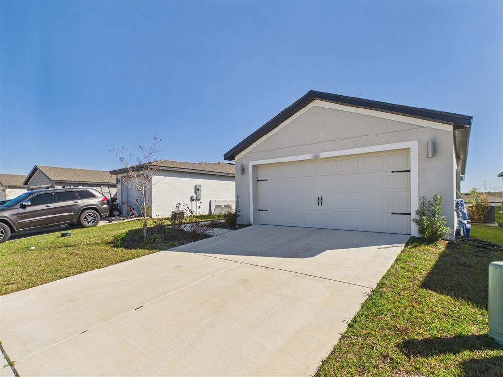 5194 Sailor Road Brooksville, FL 34602 - Photo 24 of 26 a front view of a house with a yard and garage