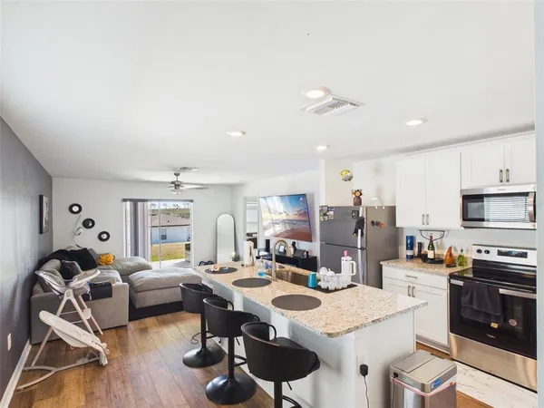 a large kitchen with a table and chairs