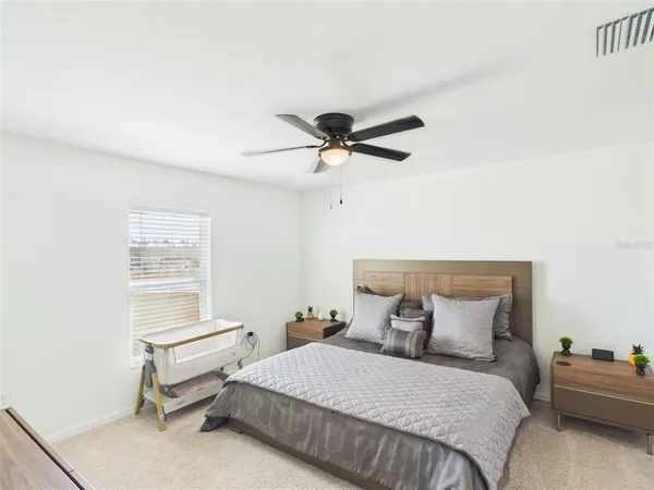 a bedroom with a bed and window