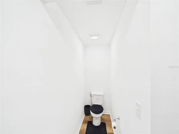 a bathroom with a toilet and a mirror