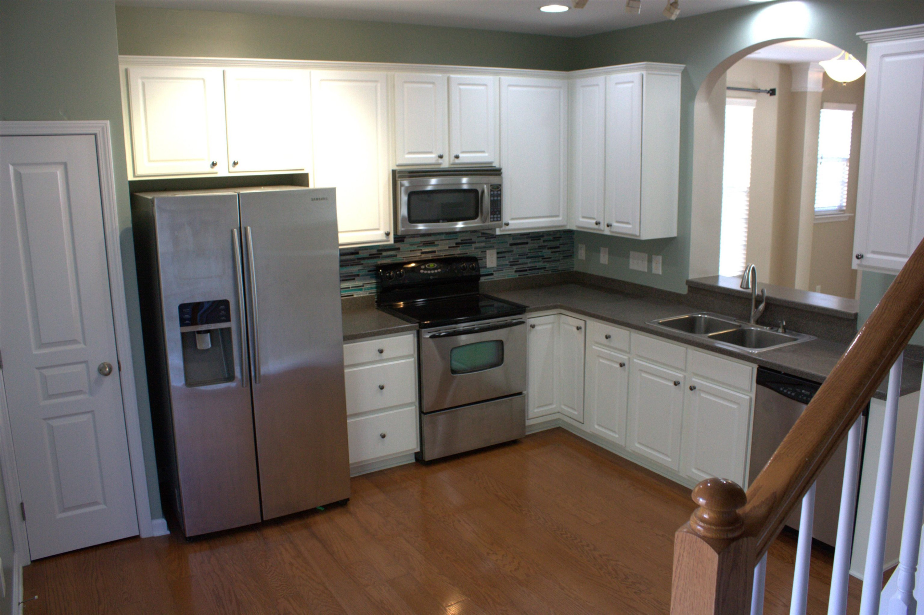 7802 Spungold Street Raleigh, NC 27617 - Photo 7 of 23 Kitchen has a full pantry, ample cabinet storage and solid surface counters. Smooth top range and side-by-side door fridge. All appliances convey! Kitchen