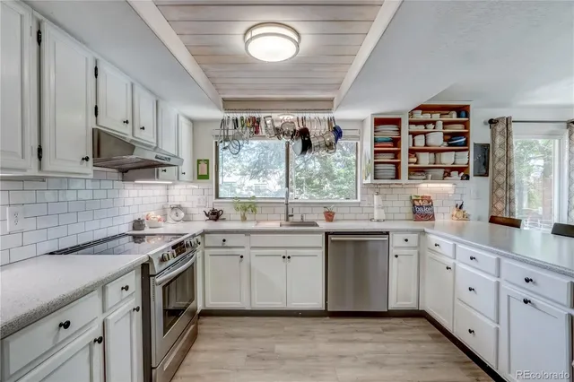 a kitchen with a sink stove and cabinets
