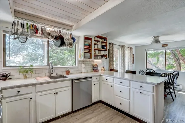 a kitchen with a sink window and cabinets