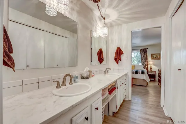 a en suite bathroom with double vanity and a mirrors