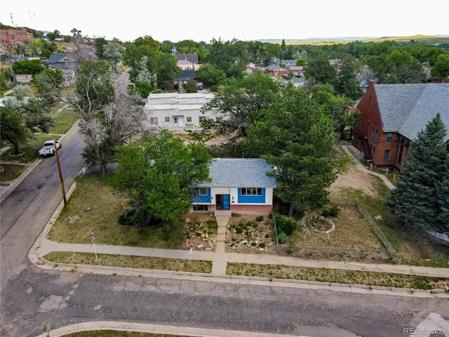 an aerial view of a house with a yard